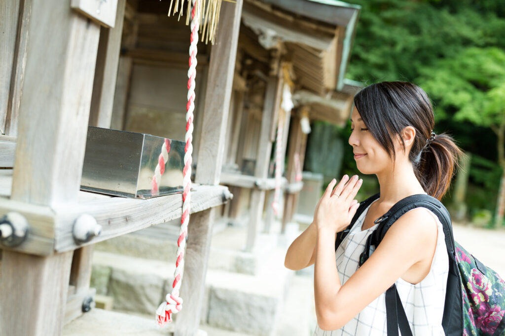 Woman wishing in Japanese temple